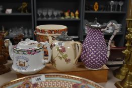 A 19th century baluster form pitcher, decorated with three leaf clovers on a purple ground, having
