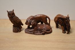 A group of hand carved Chinese box wood animal, to include a mother elephant with her cub, tigers