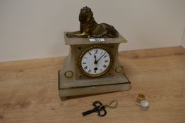 A French alabaster and gilt metal mantel clock, having a recumbent lion surmount over an enamelled