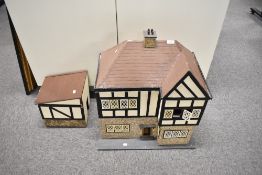 A vintage hand made wooden two storey Dolls House having plastic windows and attached Out House,