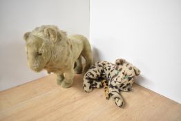 A straw filled and plush Lion having plastic eyes, stitched nose and mouth, length 38cm along with a