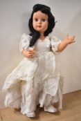 A 1950's Milano Doll having sleep eyes, closed mouth, jointed body, fully clothed with original size