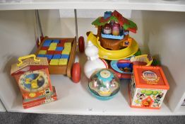A shelf of vintage Toys including Fisher Price Teaching Clock, Jack in the Box, Roly Poly Chime Ball