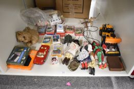 A shelf of mixed Toys including Top Trumps x 12, modern Puppets, vintage plush Cat, plastic Loader