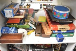 A shelves of vintage Games including Cluedo, Monopoly, Halma, Rummikub, Stratego, two wooden boxes