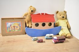 A shelf of vintage toys including a wooden Noah's Ark with animals, two 1950's straw filled and