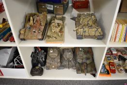 Two shelfs of plastic scale model kit built Military Tanks and Vehicles, some with remote