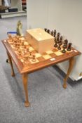 A modern Chess board table with a complete set of modern wooden Chess pieces in wooden box