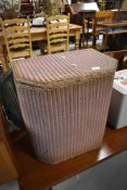 A vintage Lloyd Loom linen basket in pink