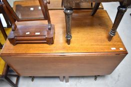 A Victorian mahogany drop leaf dining table having turned legs, approx width 108cm