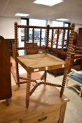 A Victorian corner chair having bobbin turned frame and strung seat