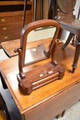 A Victorian mahogany toilet mirror of small proportions with drawer base