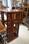 A reproduction stained frame revolving bookcase
