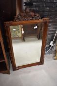 A reproduction wall mirror having carved frame