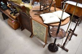 An early 20th Century standard lamp table with twist frame, and two fire screens