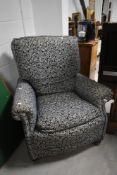 An early 20th Century easy armchair having later upholstery