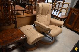 A Stressless cream leather recliner and footstool having chrome frame, from the Mayfair signature