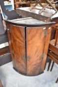 A 19th Century mahogany bow fronted corner cupboard