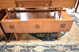 A vintage teak sideboard having wooden handles , width approx. 146cm