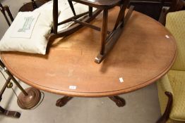 A Victorian mahogany loo table of oval form having tilt top, on turned column and quadruple scroll