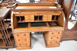 A Victorian golden oak barrel top desk, width approx. 134cm