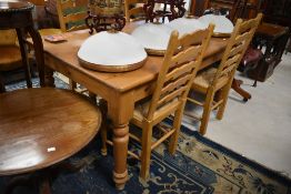 A traditional pine kitchen table, approx 151 x 91cm and a set of four rush seated ladder back