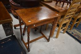 An early 20th Century oak side table, on turned frame