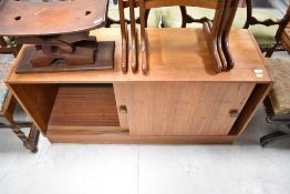A vintage teak bookcase base, having sliding doors, width approx. 122cm