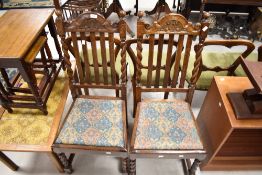 A pair of early 20th Century oak rail back dining chairs