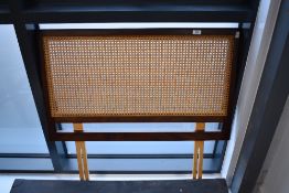 A vintage cane work single headboard
