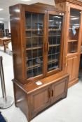 An early to mid 20th Century (in the Art Deco style) mahogany bookcase having double cupboard under,