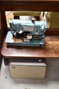 A vintage Singer electric sewing machine and case , probably mid 20th Century