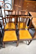 A set of four early 20th Century mahogany dining chairs having dralon drop in seats