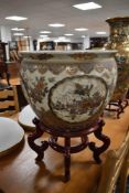 A reproduction Chinese fish bowl on stand