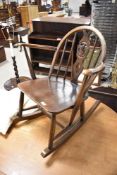 A vintage dark stained Ercol low rocking chair