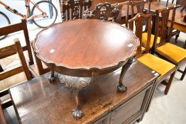 An early 20th Century coffee table having scallop edge on ball and claw feet
