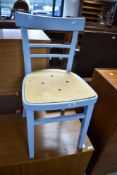 A painted kitchen chair having ply seat