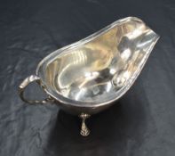 A George V silver sauce boat, of traditional form having a moulded rim and generous spout opposed by