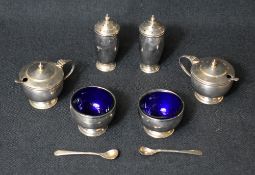 A cased George V silver condiment set, comprising two salts, two mustards and two pepperettes, all