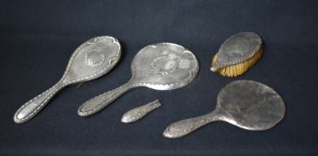 An early 20th century silver mounted vanity set, comprising a hair brush and a mirror, all with