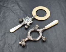 An Edwardian silver babies' rattle, of circular form having embossed decoration and three bells,
