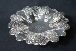 An Edwardian silver pedestal fruit bowl, having a lobed rim with embossed floral decoration and