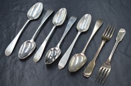 A set of two early William IV silver fiddle pattern dessert forks, one having a stag heraldic