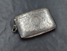 A George V silver vesta case, of rectangular form having engraved scroll decoration and central