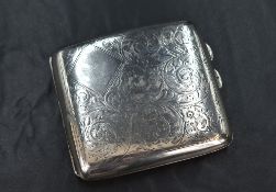 A George V silver cigarette case of hinged rectangular form, curved for the gentleman's pocket,