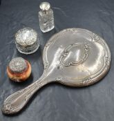 An Edwardian silver mounted mirror, having embossed leaf and scroll work with a central cartouche