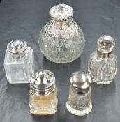An assortment of silver mounted and capped cut glass vanity wares, comprising scent bottles and