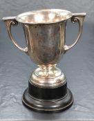 A George V silver trophy, of traditional form having a slightly flared rim, angular handles with