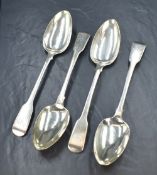 A set of four George IV silver fiddle pattern serving spoons, having 'AD' monogram to the terminals,