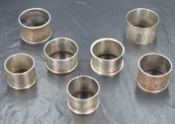 A group of eight late 19th/20th century silver napkin rings, of various size and design including